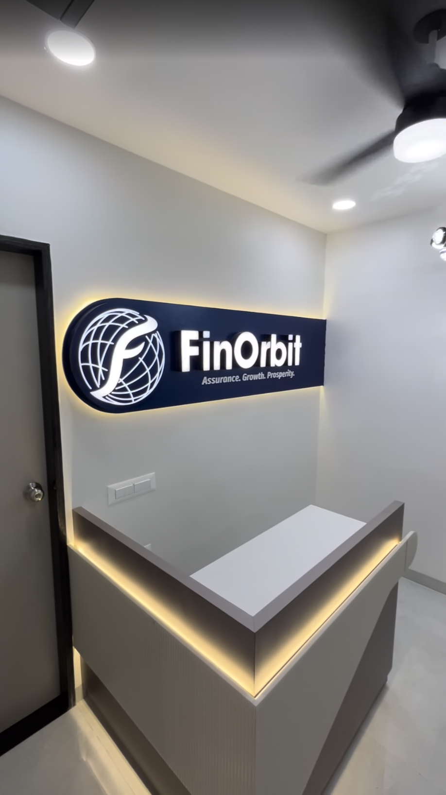 FinOrbit branded signage — Assurance. Growth. Prosperity.